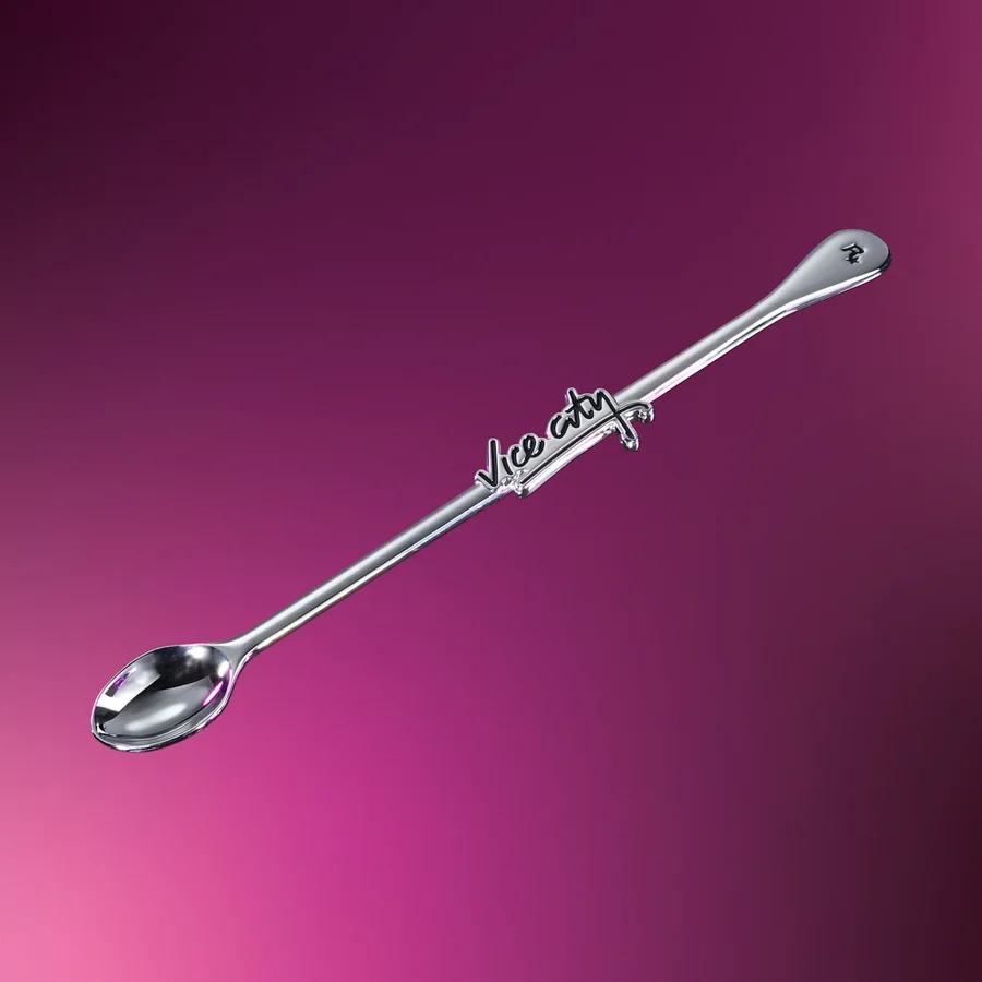 Decorative metal swizzle spoon with a debossed enamel Vice City logo
